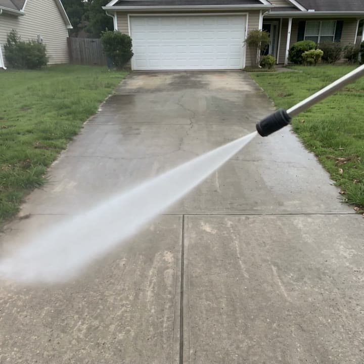 Grimy driveway pressure washed clean, stripe by stripe, a real run on Leap