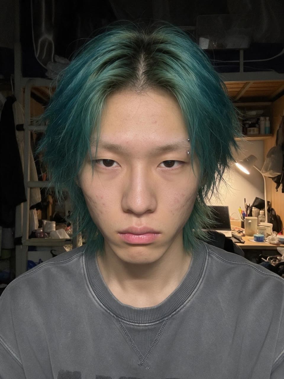 The face put into teal hair on a fashion week runway