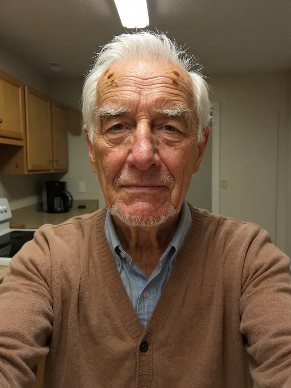 The photo grey studio headshot in his own cardigan started from